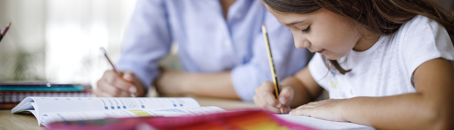 Mother helping daughter with homework